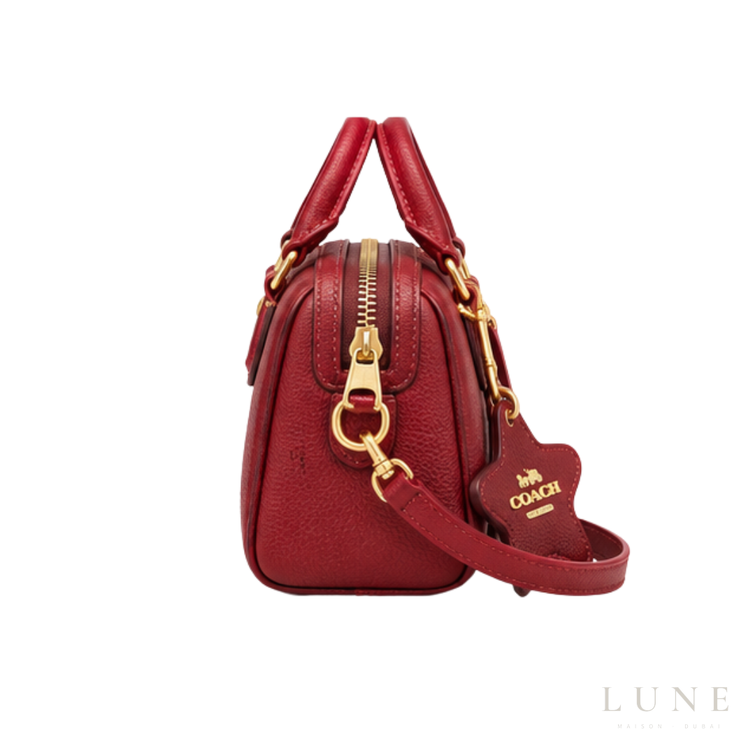 Coach Bag | Mini Rowan Crossbody Bag (featuring a prominent horse & carriage motif and matching star logo charm) – Crimson Red – Cherry (Pebbled leather with gold-tone hardware)